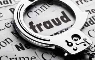 close-up image of handcuffs placed over a newspaper