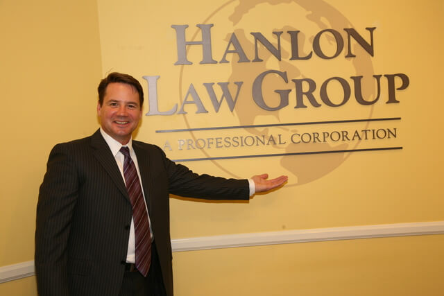 Attorney Dan Hanlon in front of office logo