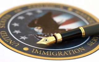 U.S. Immigration Enforcement seal and pen