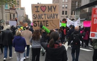 sanctuary state protest sign