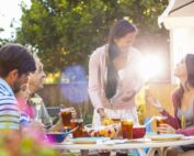 hispanic family laughing and eating together