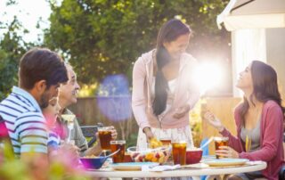 hispanic family laughing and eating together